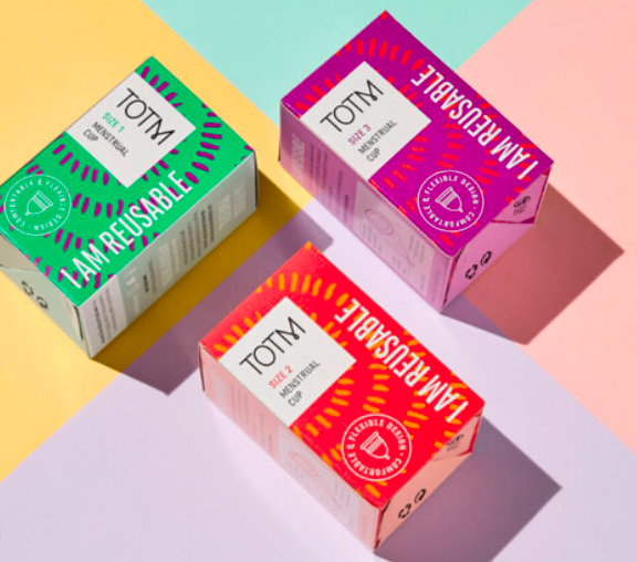 TOTM sustainable period care boxes showcasing reusable tampon packaging on a colorful background.
