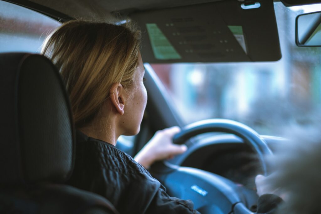 Young driver at the wheel showcasing the convenience and safety of the best electric cars for teens, encouraging eco-friendly habits from the start.