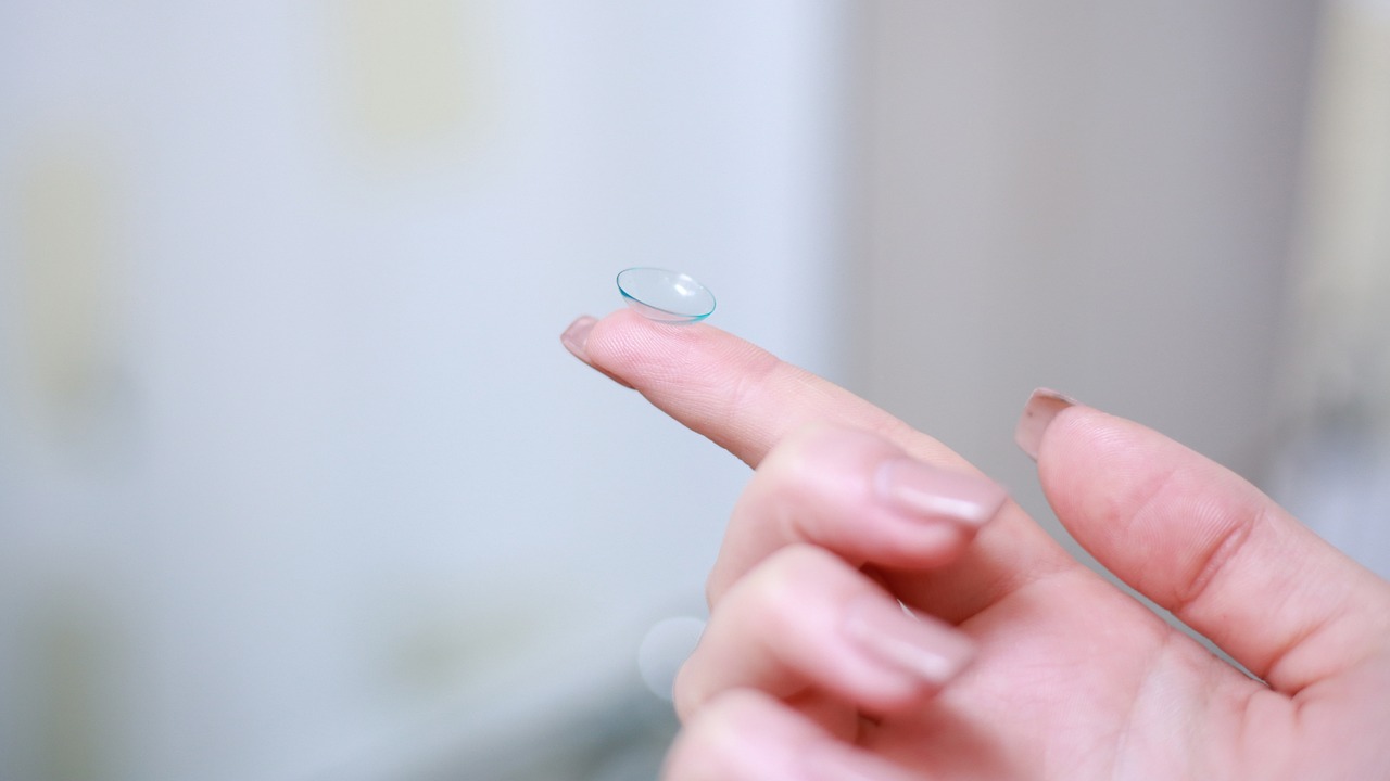 A clear contact lens balanced on a fingertip against a soft background - showcasing what to do with old contacts when learning proper handling and disposal techniques.RetryClaude can make mistakes. Please double-check responses.
