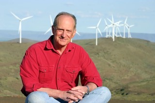 Denis Hayes sitting on grass infront of wind trubines organiser of the first Earth Day back in 1970