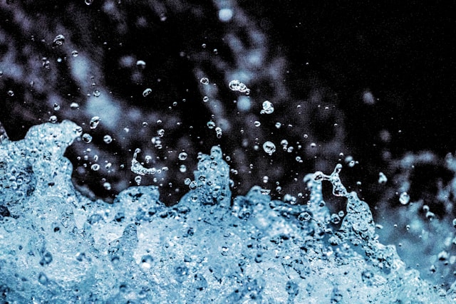 Close-up splash of water droplets in motion, representing clean hydration from a Japanese water purifier.