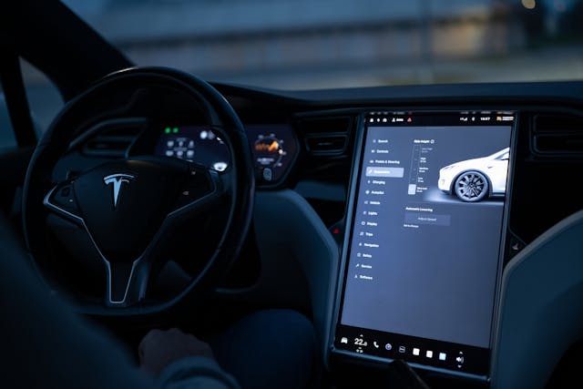 Interior view of a Tesla showing the touchscreen interface and dashboard, illustrating how Tesla vehicles manage diagnostics without a traditional check engine light.