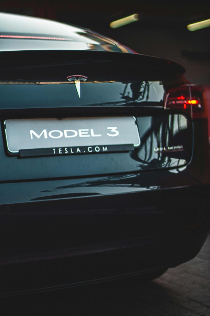 back of black model 3 tesla with a number plate saying model 3