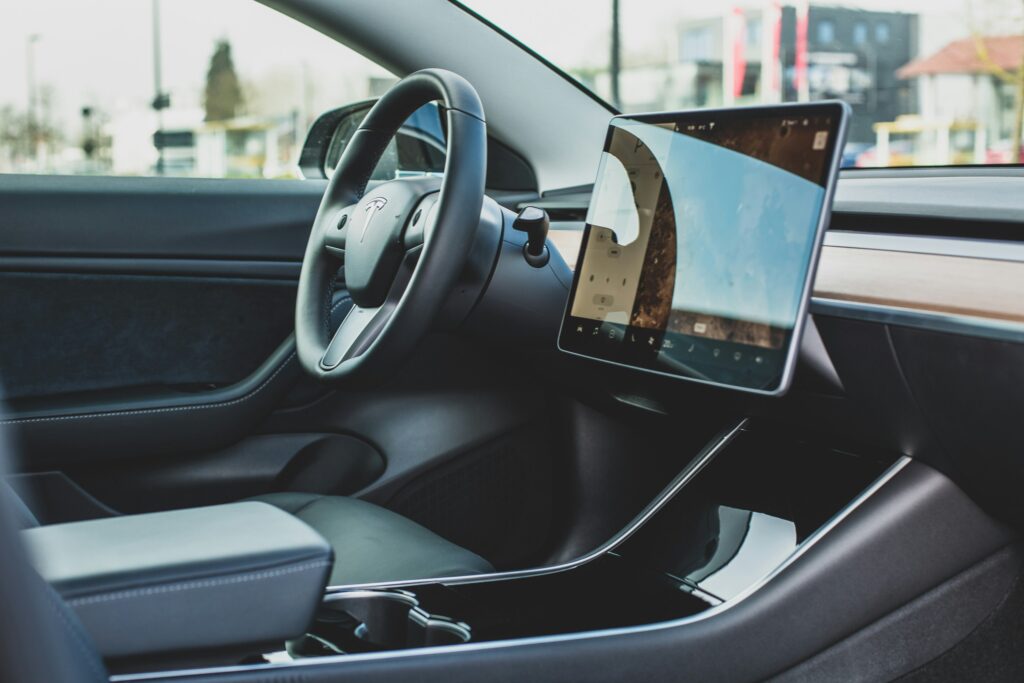 tesla side view of steering wheel and glove box