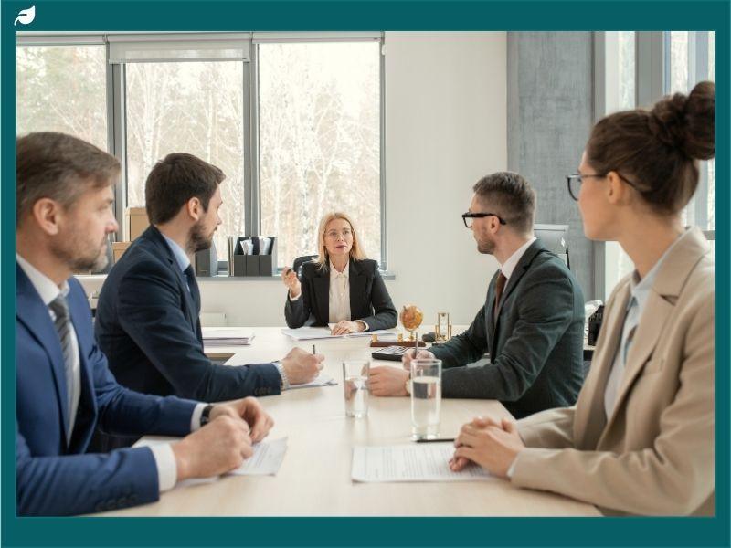 Environmental consulting firms UK team in a professional boardroom meeting, discussing sustainability strategies and business compliance solutions.