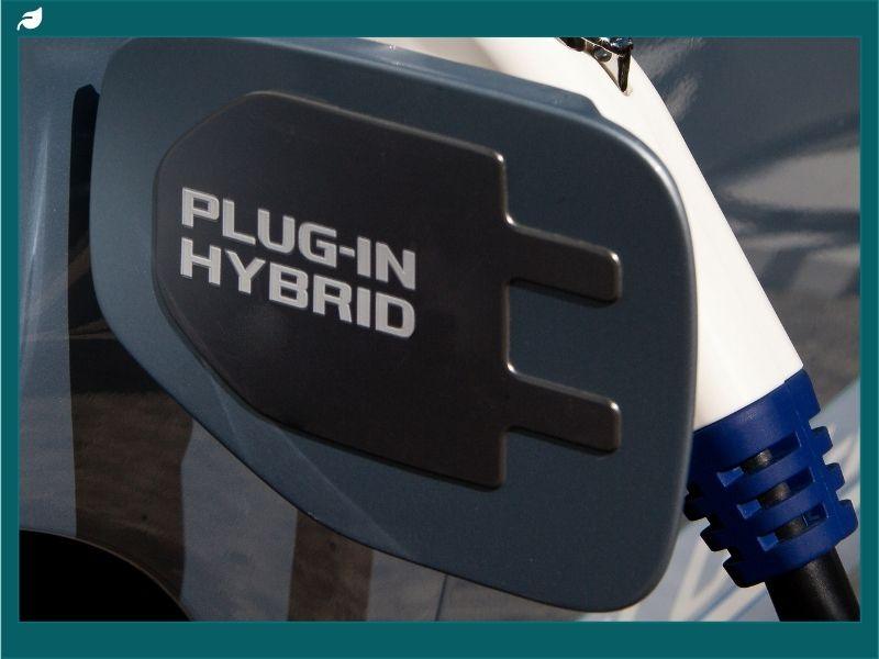 Close-up of a plug-in hybrid charging port, symbolizing the balance between fuel and battery power in the ongoing hybrid vs electric cars debate.