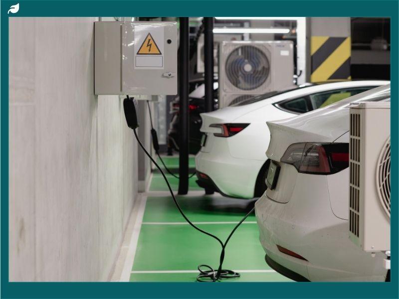 Electric cars charging at a modern station, highlighting sustainability and the growing debate of hybrid vs electric cars for eco-friendly transportation.