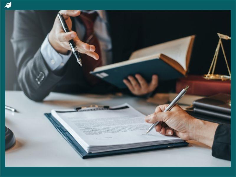 Lawyers reviewing legal documents related to the canned tuna price-fixing lawsuit settlement in the United States.