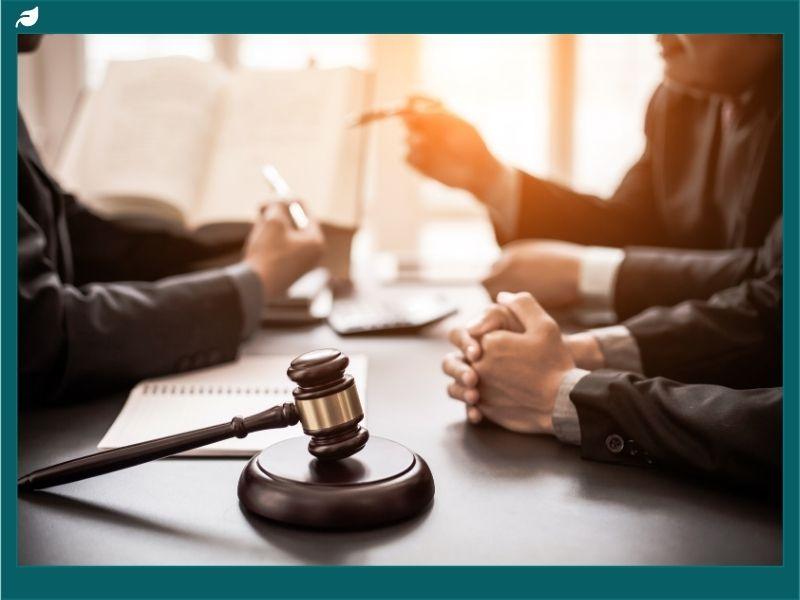 Courtroom discussion with gavel on table symbolizing the canned tuna price-fixing lawsuit settlement and legal proceedings.Courtroom discussion with gavel on table symbolizing the canned tuna price-fixing lawsuit settlement and legal proceedings.