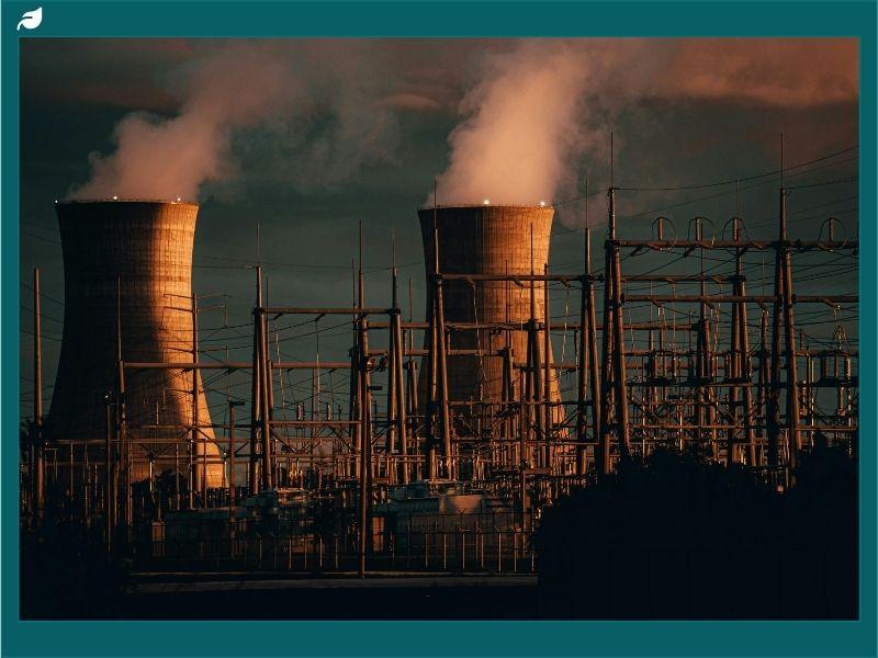 Steam rising from cooling towers at a nuclear facility representing the Zaporizhzhia nuclear power plant power outage and global nuclear energy concerns.