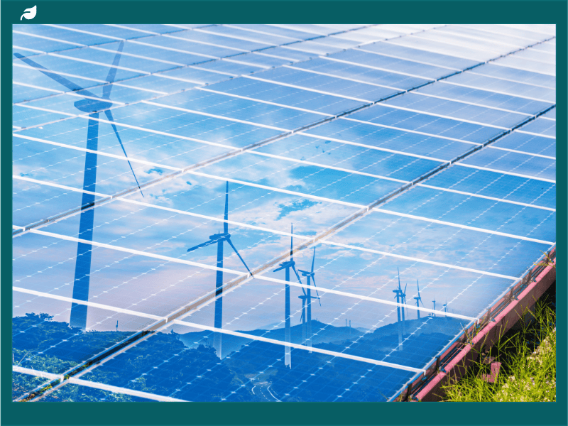 Solar panels reflecting wind turbines, illustrating renewable energy benefits and whether solar panels are worth it in the UK.