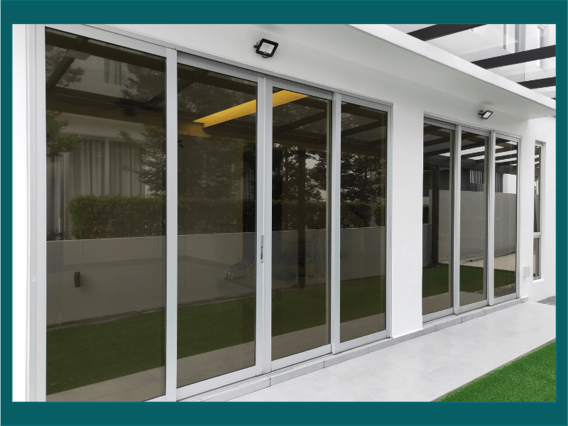 Modern energy-efficient sliding glass doors and insulated windows installed in a contemporary home exterior for improved energy savings.”