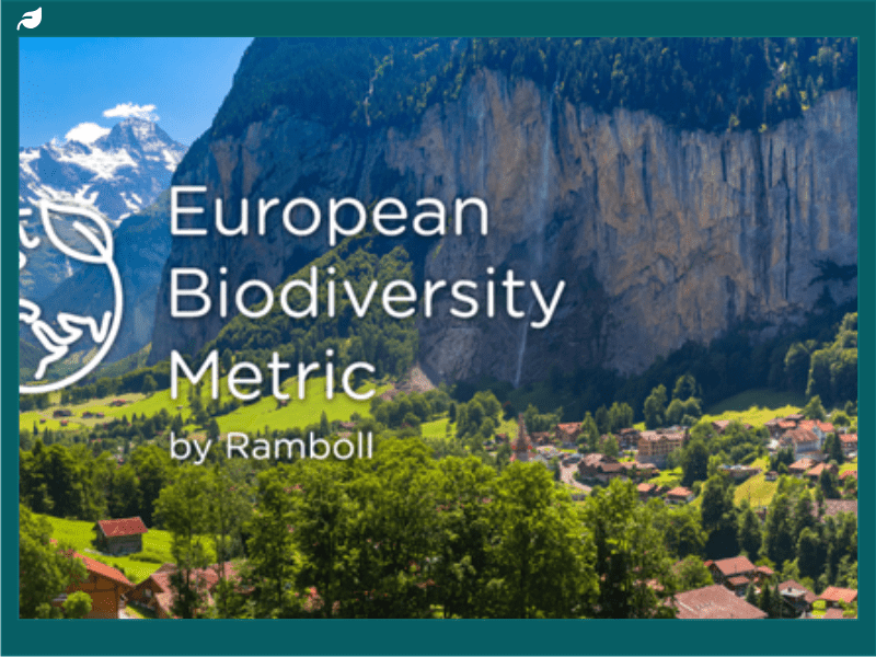 European Biodiversity Metric Logo above an image of a mountain town nestled in amongst the cliffs