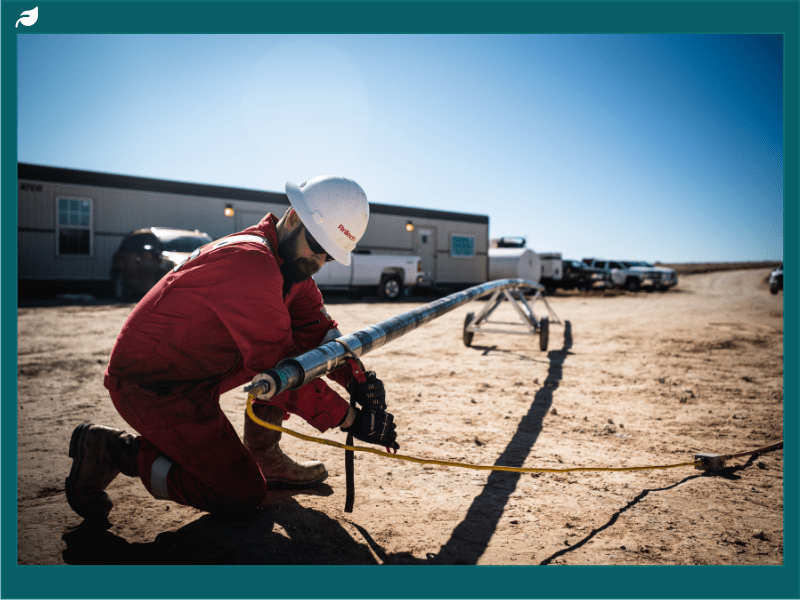 A worker kneeling next to AnTech's Specialist Colied Tubing Drilling Tool