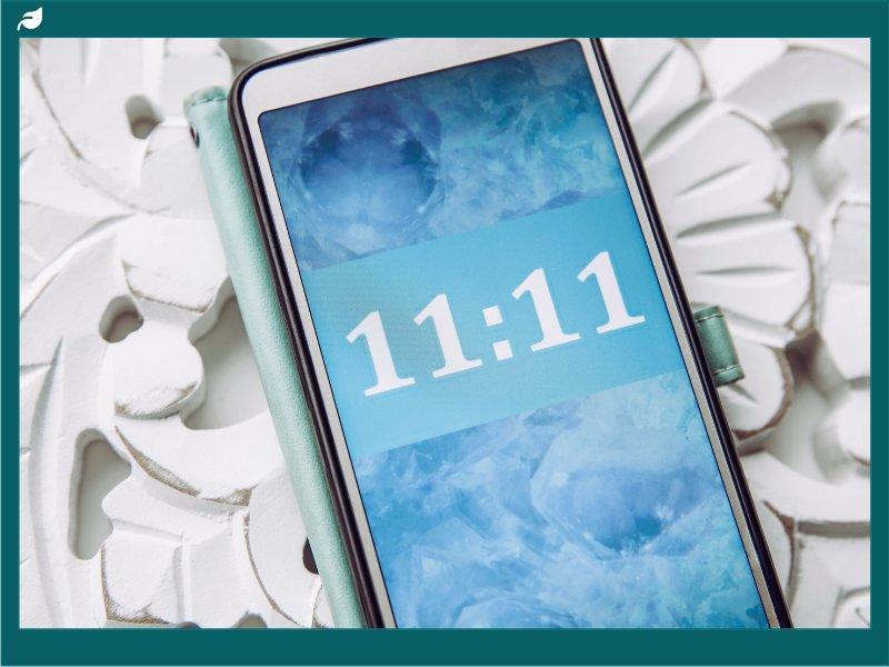 Smartphone showing 11:11 time on icy blue crystal wallpaper
