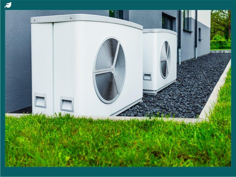 Air source heat pump units installed outdoors beside residential building
