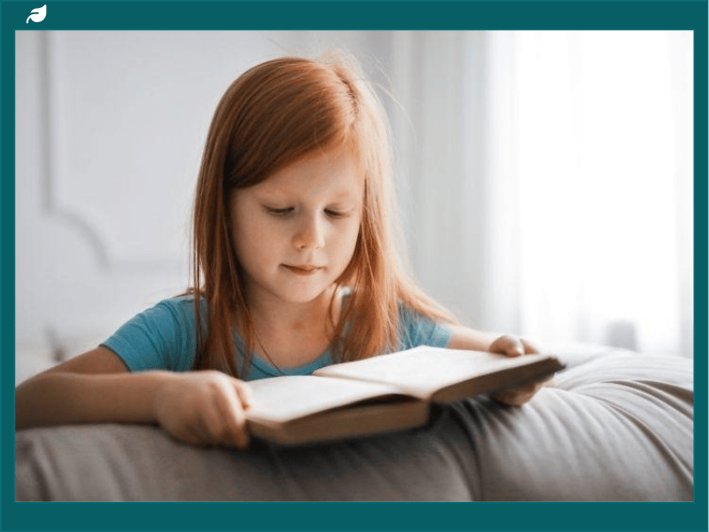 Girl in Blue T-shirt Reading Book
