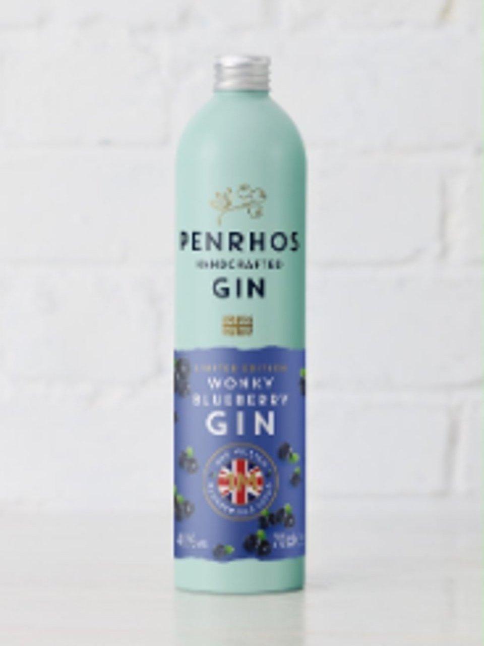 A bottle of Penrhos honey blueberry gin against a white tiled background.