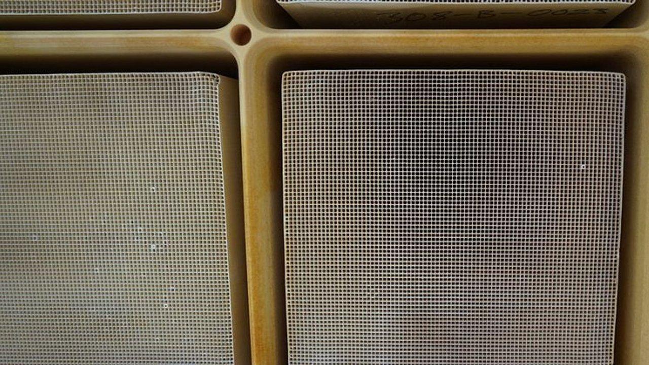 Close-up of beige speaker grilles in a molded plastic panel