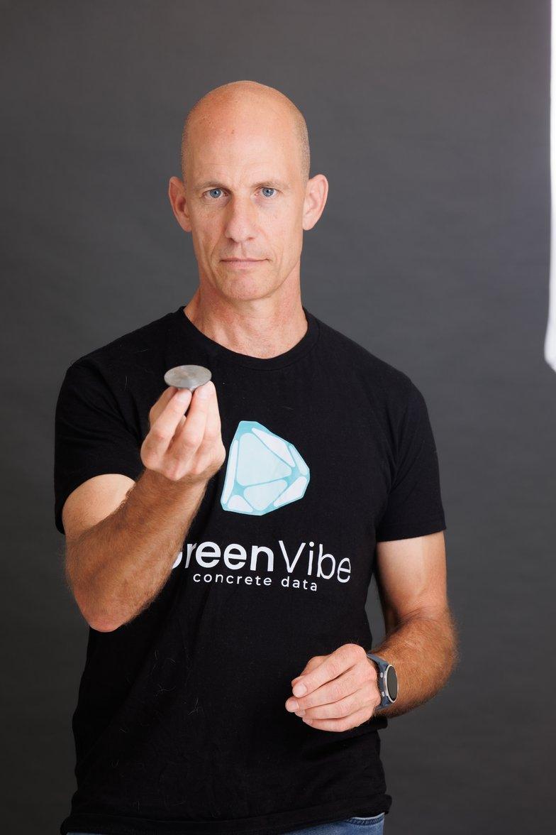 Roee Reshef, CEO and Co-Founder of GreenVibe, holding a wireless concrete sensor