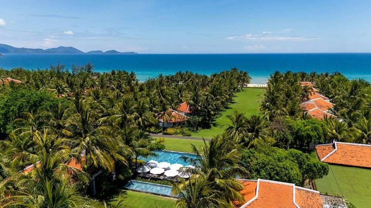 Aerial view of The Anam resort with tropical gardens, pools and beachfront in Vietnam