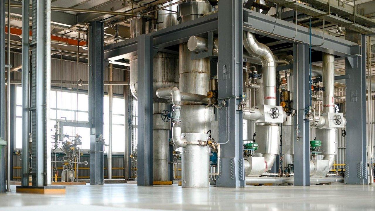 Industrial interior of the Blanes nylon 6,6 production facility with pipes and tanks