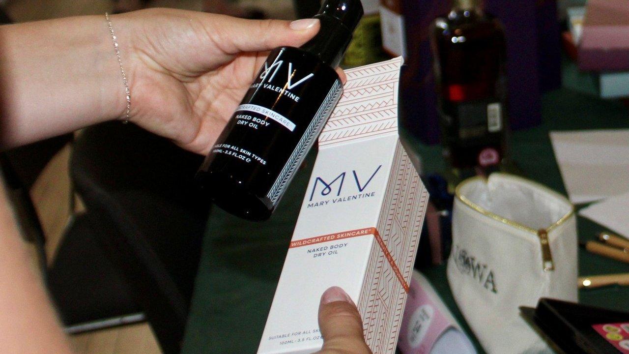 Hands holding a bottle of packaging product at London Packaging Week event