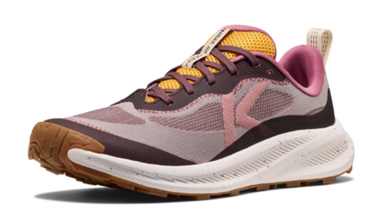 A pink, purple and yellow running shoe with a thick white sole and gum outsole.