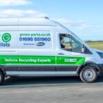 A Green Parts Specialists vehicle recycling van driving along a rural road