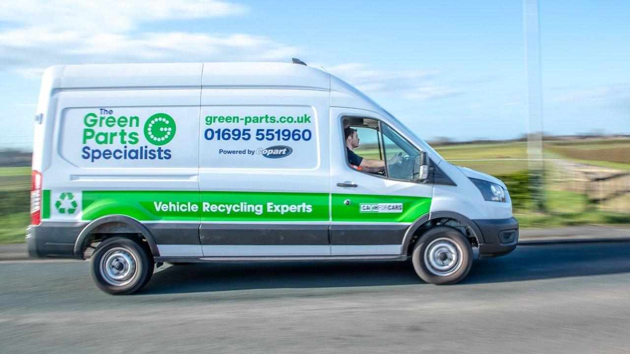 A Green Parts Specialists vehicle recycling van driving along a rural road
