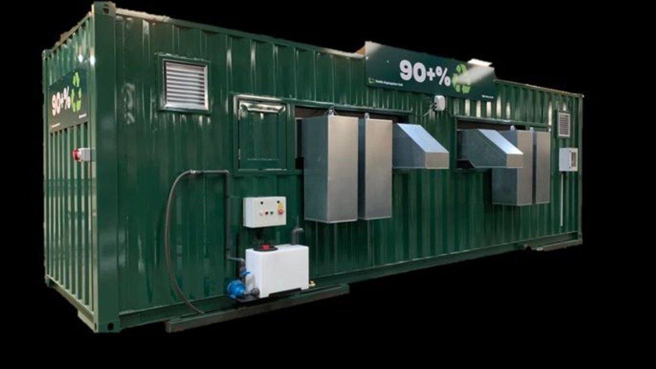 Green waste management container with metal chutes, control box and 90% recycling symbols.
