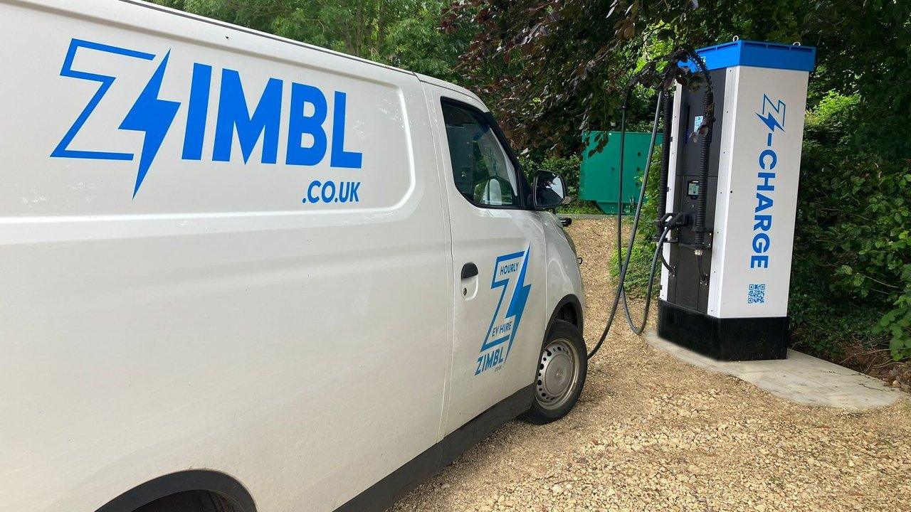 Zimbl electric van charging at a Z-Charge station beside trees