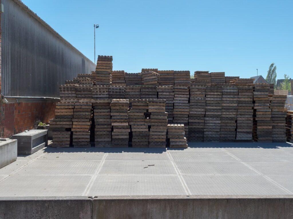 Salvaged lumber and reclaimed building materials stacked on racks in a warehouse