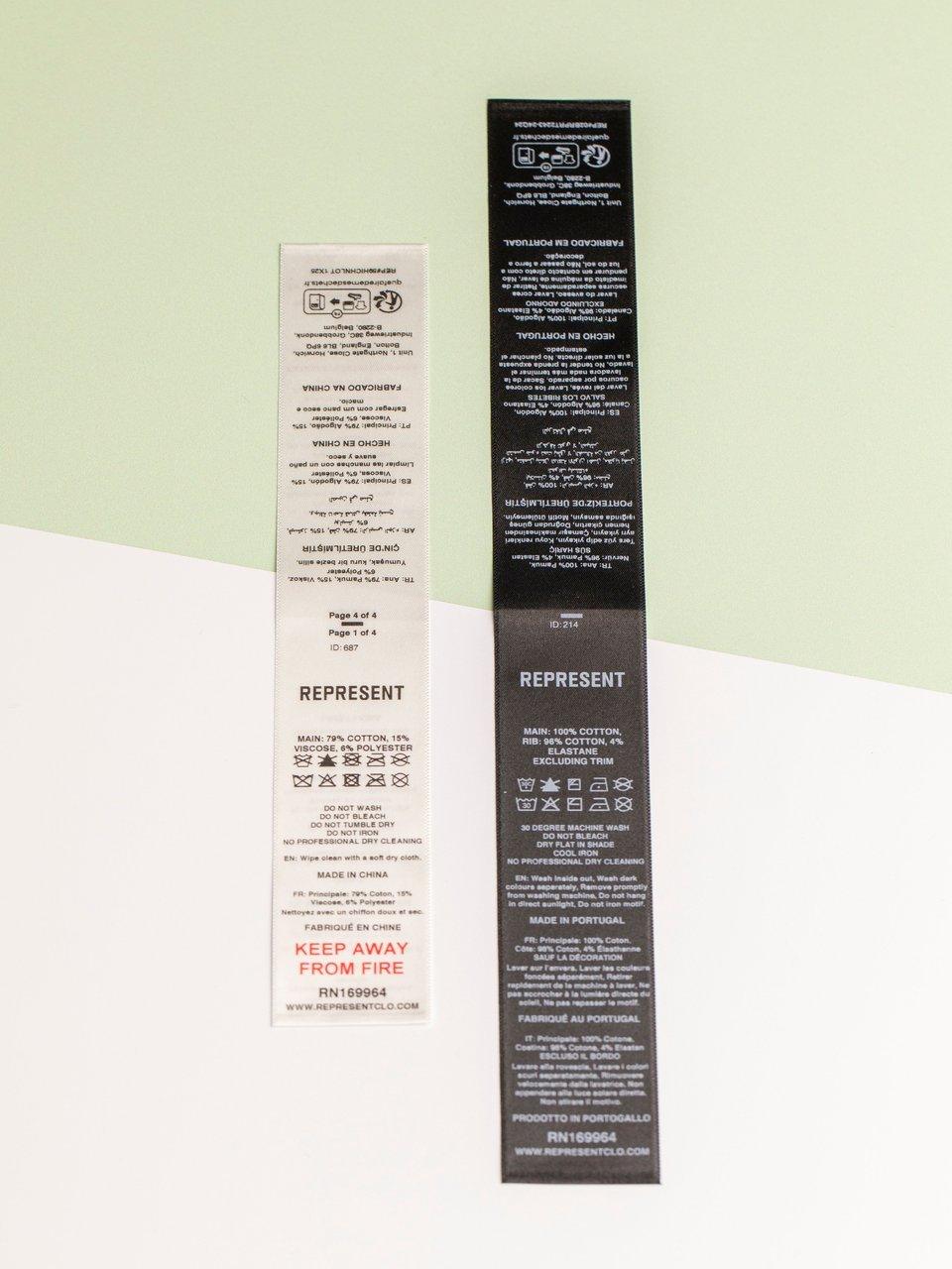 Two Represent garment care labels, one white and one black, on a pale green and white background.