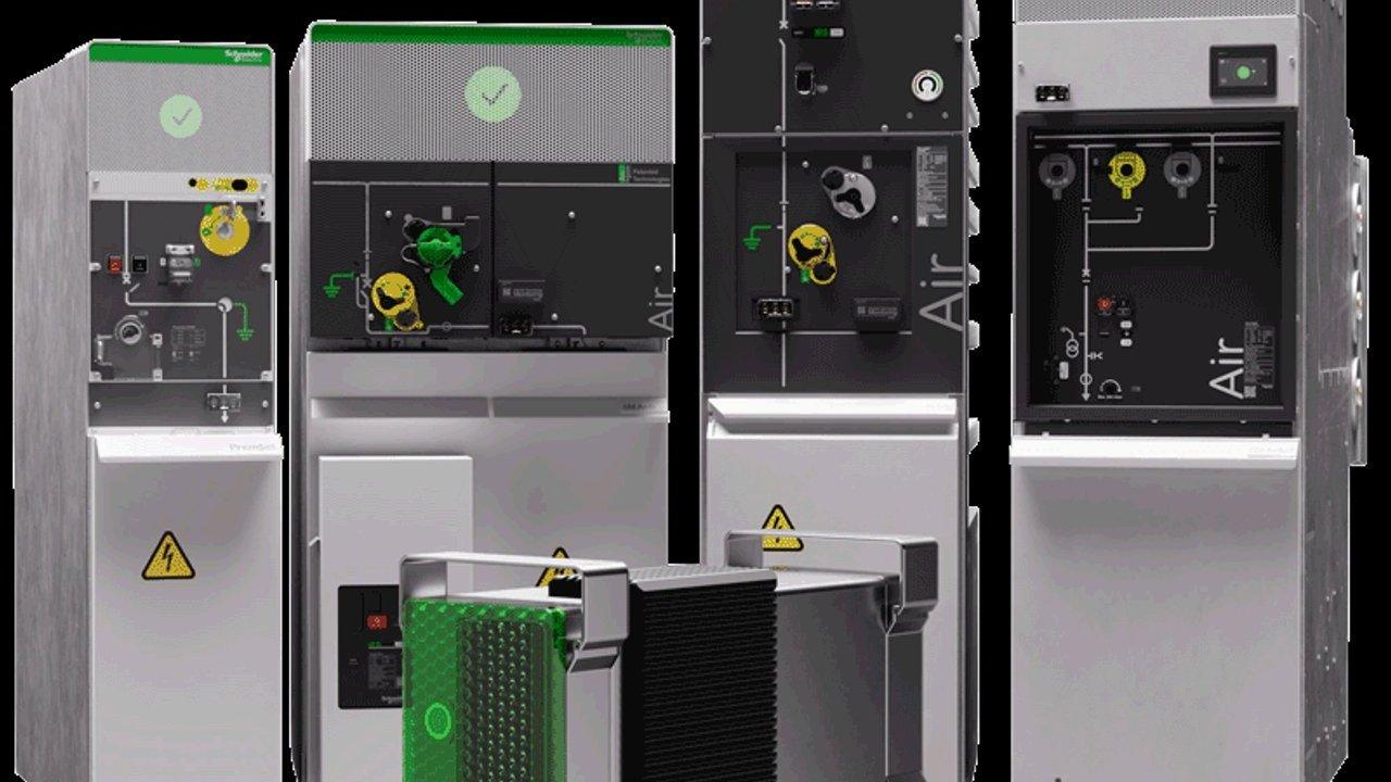 Four industrial electrical cabinets with control panels and a removable black-and-green module.