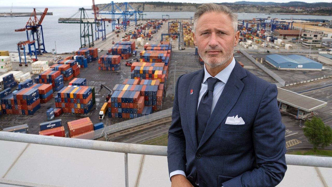 Ivan Jimenez Aira in front of container stacks and cranes at the Port of Bilbao.