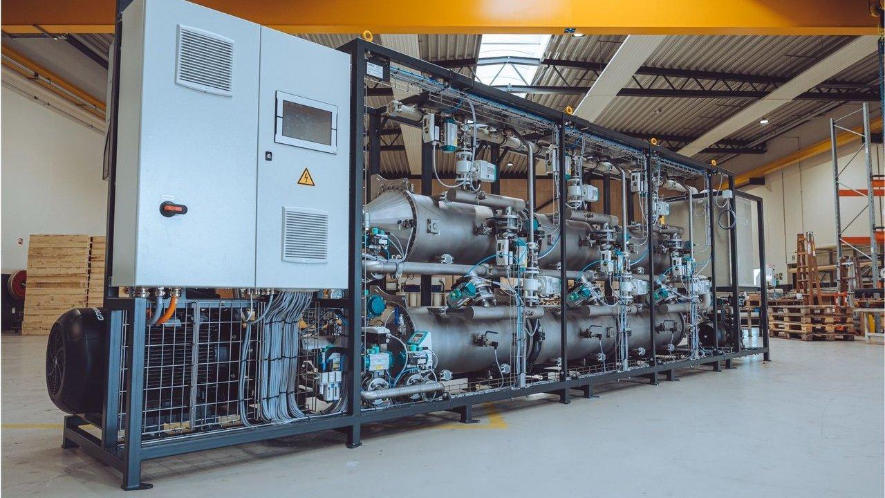 QureFlow water treatment system with tanks, pipes and control cabinet in an industrial facility
