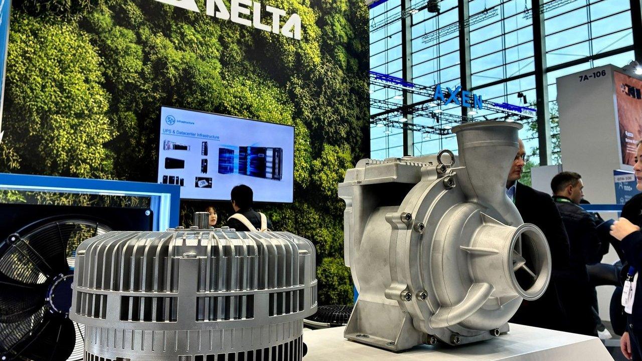 Industrial motor and centrifugal pump displayed at a trade show booth.