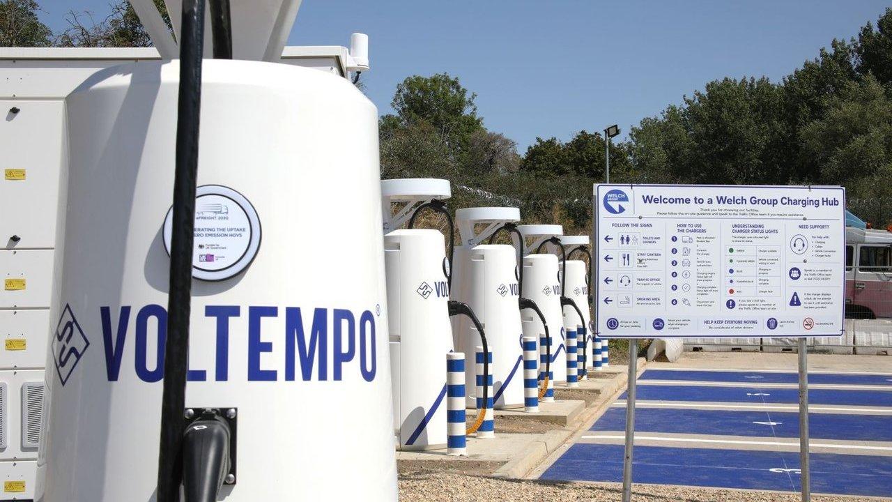 Voltempo electric vehicle charging stations beside blue parking bays and a Welch Group Charging Hub sign