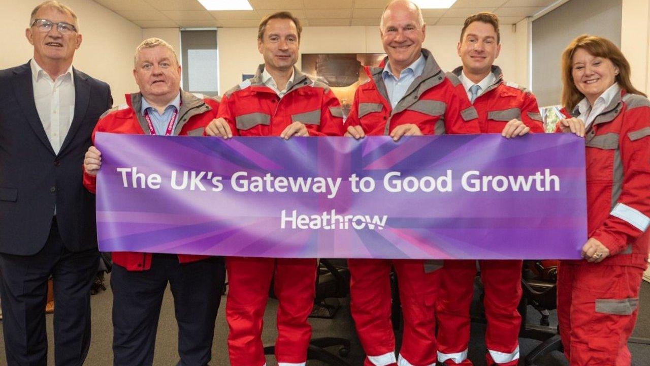 Six people hold a Heathrow banner reading “The UK’s Gateway to Good Growth.”