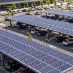 Solar-panel carports shading parked cars outside a shopping center.