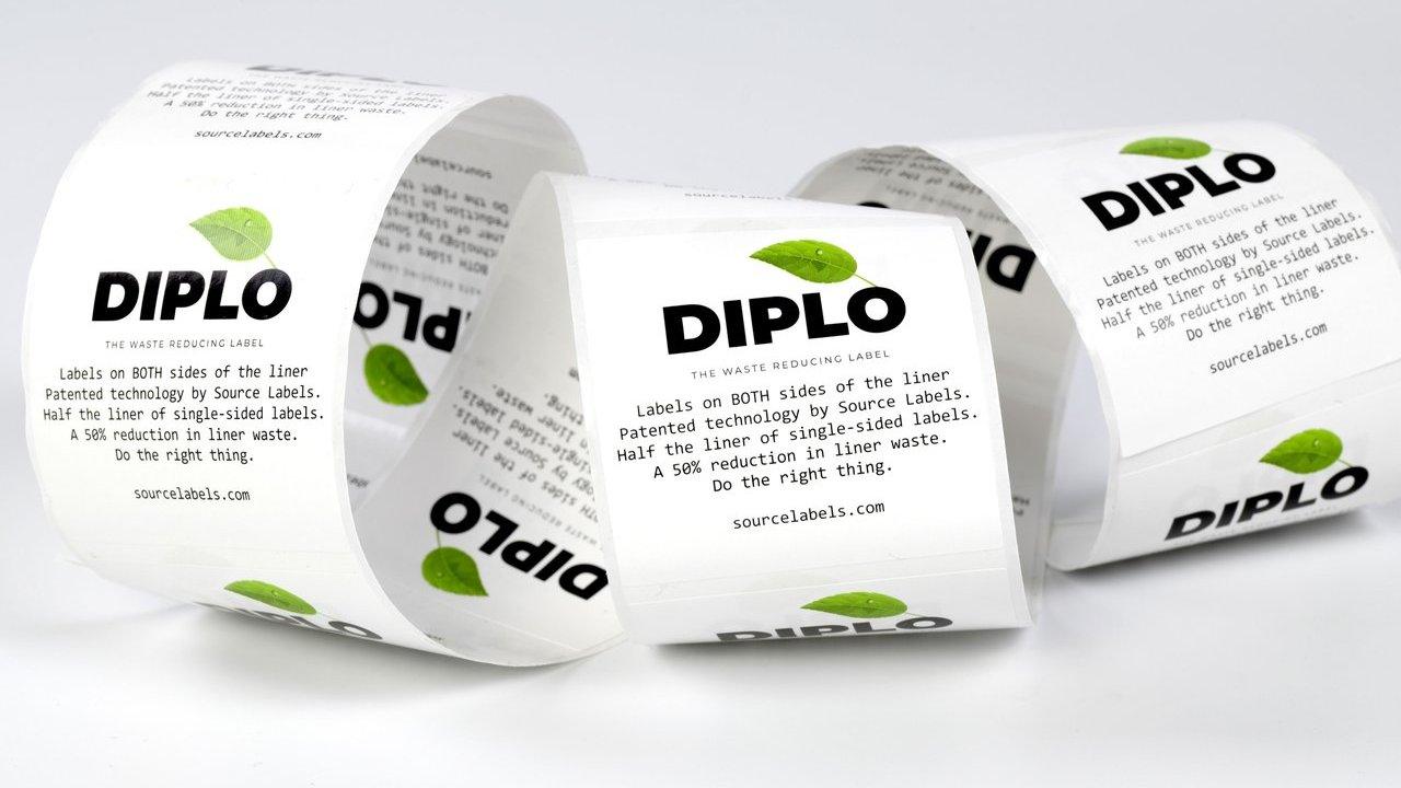 Three coiled rolls of DIPLO labels with green leaf logos on a white background.